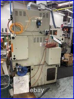 1997 Takisawa TW-30 L5 CNC 2 axis Lathe with tool holders, spares, and conveyor